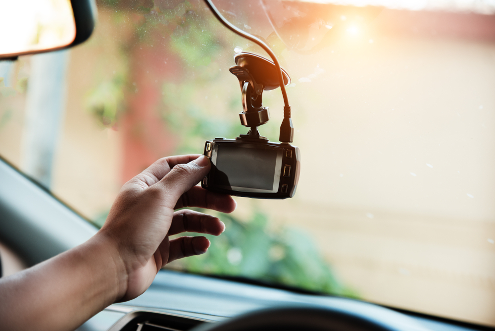 The human hand is touching the dashcam