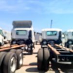 Blurry scene of group of trailer truck parking on the yard for background