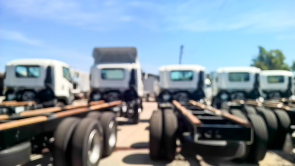Blurry scene of group of trailer truck parking on the yard for background