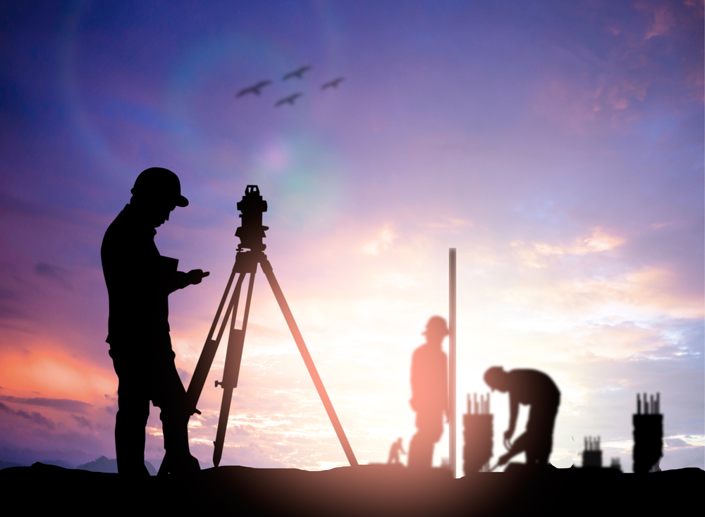 silhouette black man survey civil engineer stand on ground working in a land building