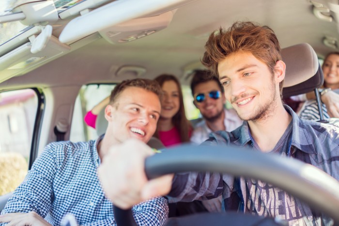 teen driving with a group of friends